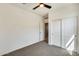 This carpeted bedroom features a ceiling fan, closet and natural light at 19685 W Roma Ave, Litchfield Park, AZ 85340