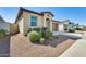 Well-manicured front yard with lush landscaping, a two-car garage, and a charming entrance at 19685 W Roma Ave, Litchfield Park, AZ 85340