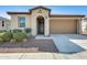Charming single-story home with a well-maintained front yard and attached two-car garage at 19685 W Roma Ave, Litchfield Park, AZ 85340