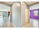 Bright hallway featuring an open floorplan with views of the backyard, a living room, and a bedroom at 19685 W Roma Ave, Litchfield Park, AZ 85340