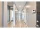 Long hallway featuring wood-look tile flooring, neutral paint, and recessed lighting at 19685 W Roma Ave, Litchfield Park, AZ 85340