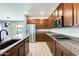 Modern kitchen featuring granite countertops, stainless steel appliances, and wood cabinetry at 19685 W Roma Ave, Litchfield Park, AZ 85340