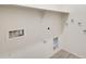 Bright laundry room with washer and dryer hookups plus shelving at 19685 W Roma Ave, Litchfield Park, AZ 85340