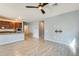 Open concept living space with access to the kitchen and dining area, featuring light tile floors at 19685 W Roma Ave, Litchfield Park, AZ 85340