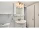 Bright bathroom featuring a vanity with storage, a decorative mirror, and a neutral color palette at 2048 W Elm St, Phoenix, AZ 85015