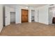 Large bedroom featuring tile floors, built-in wooden wardrobe, and an ensuite bathroom at 2048 W Elm St, Phoenix, AZ 85015