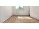 Bright, empty bedroom featuring tile flooring and a window providing natural light at 2048 W Elm St, Phoenix, AZ 85015