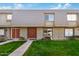 Inviting townhouse featuring charming architecture, a well-manicured lawn, and a welcoming facade at 2048 W Elm St, Phoenix, AZ 85015