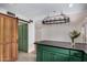 Well-designed kitchen with an island, a unique chandelier, and an adjacent barn door adding character to the space at 2048 W Elm St, Phoenix, AZ 85015