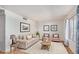 Bright living room with tile flooring, neutral paint, comfortable seating, and abundant natural light at 2048 W Elm St, Phoenix, AZ 85015