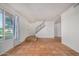 Spacious living room featuring terracotta tile flooring, white walls and staircase at 2048 W Elm St, Phoenix, AZ 85015