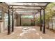 Charming outdoor patio with a pergola, offering a cozy space for relaxation and entertaining amidst lush greenery at 2048 W Elm St, Phoenix, AZ 85015