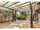 Spacious outdoor patio featuring a pergola, tile flooring, and surrounded by privacy landscaping at 2048 W Elm St, Phoenix, AZ 85015