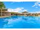 Serene community pool offers clear water, shaded areas, and comfortable lounge chairs for relaxation and recreation at 2048 W Elm St, Phoenix, AZ 85015