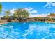 Sparkling community pool with clear blue water, sunshades, and ample space for lounging and relaxation at 2048 W Elm St, Phoenix, AZ 85015