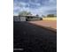 Expansive backyard featuring a blend of dark and light gravel, enclosed by a mix of fences and structures at 2224 W Fairmount Ave, Phoenix, AZ 85015