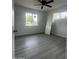 Bedroom featuring modern flooring, a ceiling fan with a light, and bright windows at 2224 W Fairmount Ave, Phoenix, AZ 85015