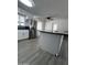 Modern kitchen with island, stainless steel refrigerator, and open layout at 2224 W Fairmount Ave, Phoenix, AZ 85015