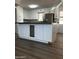 Well-lit kitchen featuring an island and stainless steel refrigerator at 2224 W Fairmount Ave, Phoenix, AZ 85015