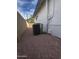 A practical side yard with gravel, housing the AC unit alongside the home's exterior wall at 2224 W Fairmount Ave, Phoenix, AZ 85015