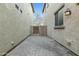 Paver backyard between two buildings with a gate at 25824 N 54Th Ave, Phoenix, AZ 85083