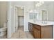 Bathroom featuring a double vanity with wood cabinets, tile floor, and a walk in closet at 25824 N 54Th Ave, Phoenix, AZ 85083