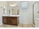 Bathroom with dual sinks, wood cabinets, tile flooring, and a shower at 25824 N 54Th Ave, Phoenix, AZ 85083