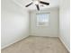 Bright bedroom featuring plush carpet, a ceiling fan, and a window providing natural light at 25824 N 54Th Ave, Phoenix, AZ 85083