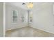 An empty bedroom with tiled floors, three windows, and neutral walls at 25824 N 54Th Ave, Phoenix, AZ 85083