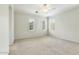Spacious bedroom featuring carpet floors and three bright windows at 25824 N 54Th Ave, Phoenix, AZ 85083