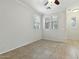 An empty bedroom featuring tile flooring, white walls, and a window at 25824 N 54Th Ave, Phoenix, AZ 85083