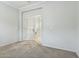 Well-lit bonus room featuring plush carpet, white walls, and elegant french doors at 25824 N 54Th Ave, Phoenix, AZ 85083