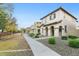 Tan-colored two-story home featuring a red tiled roof and well-maintained landscaping at 25824 N 54Th Ave, Phoenix, AZ 85083