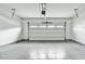 Garage with gray floor and white garage door at 25824 N 54Th Ave, Phoenix, AZ 85083