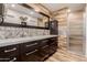 Bathroom showcasing double sinks with a large mirror, decorative tile and a glass shower at 26242 S Thistle Ln, Sun Lakes, AZ 85248
