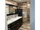 Bathroom showcasing double sinks with a large mirror, decorative tile and a glass shower at 26242 S Thistle Ln, Sun Lakes, AZ 85248