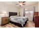 Bedroom featuring a leather headboard, wood-look flooring and a large window at 26242 S Thistle Ln, Sun Lakes, AZ 85248