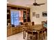 The dining room features built-in shelves and display cases, tile flooring, and ample natural light at 26242 S Thistle Ln, Sun Lakes, AZ 85248