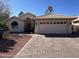 Attractive single-story home featuring a two car garage and a desert landscaped front yard at 26242 S Thistle Ln, Sun Lakes, AZ 85248