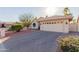 Inviting single-story home with a two-car garage and beautiful desert landscaping at 26242 S Thistle Ln, Sun Lakes, AZ 85248