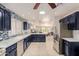 Open concept kitchen boasts stainless appliances, plentiful storage, and great natural light at 26242 S Thistle Ln, Sun Lakes, AZ 85248