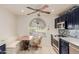 Cozy eat-in kitchen boasts stainless appliances, blue cabinets, and a breakfast nook with backyard views at 26242 S Thistle Ln, Sun Lakes, AZ 85248