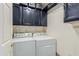 Laundry room featuring cabinets above the washer and dryer and additional storage at 26242 S Thistle Ln, Sun Lakes, AZ 85248