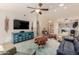 This open-concept living room is decorated with modern furniture and tile floors at 26242 S Thistle Ln, Sun Lakes, AZ 85248