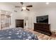 Spacious main bedroom featuring a ceiling fan, ensuite bathroom and dark wood furniture at 26242 S Thistle Ln, Sun Lakes, AZ 85248