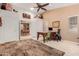 Large home office with decorative rug, neutral color palette, and access to other rooms at 26242 S Thistle Ln, Sun Lakes, AZ 85248