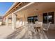 Covered patio offering comfortable seating and an inviting outdoor space for relaxation and dining at 26242 S Thistle Ln, Sun Lakes, AZ 85248
