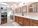 Well-lit bathroom featuring a dual sink vanity with ample storage and mirror at 26506 N 74Th Ln, Peoria, AZ 85383