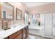 Bright bathroom showcasing double sinks, a soaking tub, and a glass shower at 26506 N 74Th Ln, Peoria, AZ 85383