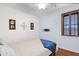 Bright bedroom featuring a ceiling fan and a window with shutters at 26506 N 74Th Ln, Peoria, AZ 85383